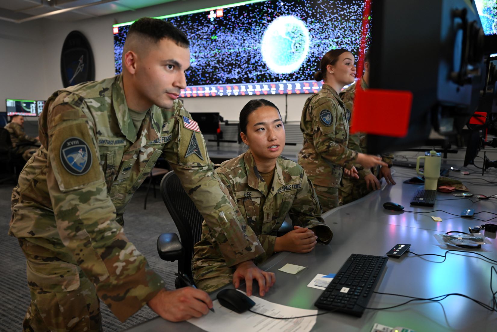 Military personnel monitoring orbital data