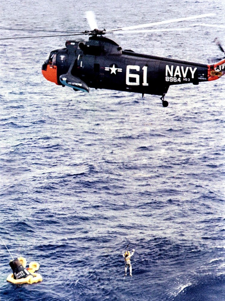 A U.S. Navy helicopter hoists Scott Carpenter from the Atlantic Ocean after his Aurora 7 splashdown