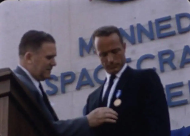 NASA Administrator James E. Webb pins the NASA Distinguished Service Medal on Scott Carpenter